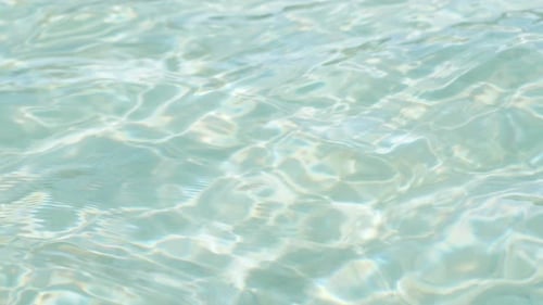 Background with Turquoise Clear Transparent Ocean Water, Closeup View.