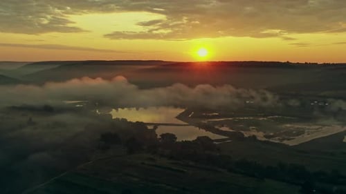 Misty Landscape with Sunset and Fog - Aerial View From a Drone
