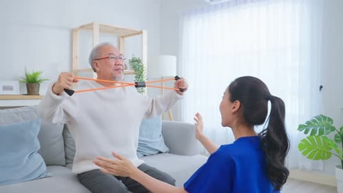 Senior Man Exercising with Resistance Band at Home