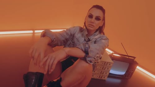 Woman Posing near Television and Wrapped Box