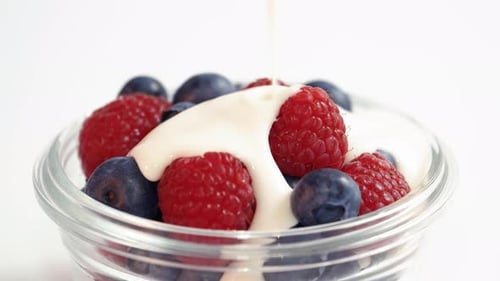 Yogurt Poured Over Fresh Blueberries and Raspberries