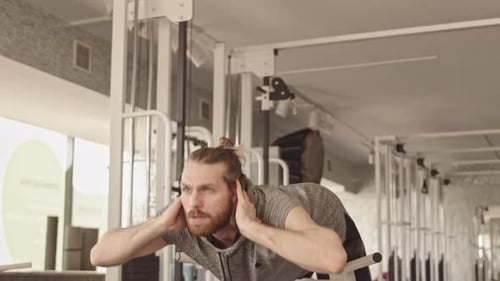 Man Doings Exercises on Abs in Gym