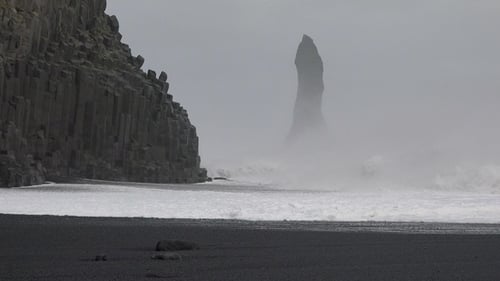 Iceland. Ocean waves hitting against the rocks on a stormy day. Huge waves crash against the rocks.