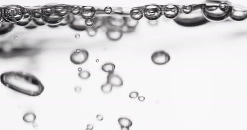 Water with Bubbles Forming on White Background