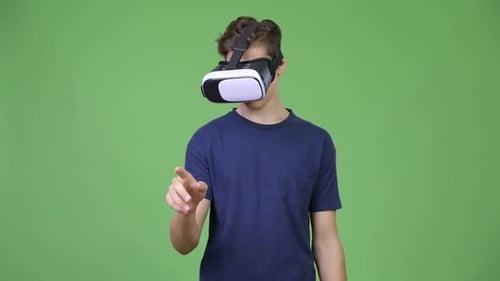 Teen Wearing VR Headset Interacts with Invisible Screen