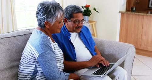 Senior Couple Using Laptop at Home Together