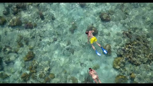 Romantic couple happy together on exotic bay beach journey by aqua blue lagoon with white sandy back