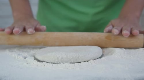 Hands Rolling Dough in a Home Kitchen