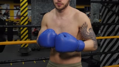 Boxer Standing in the Boxing Ring Close Up