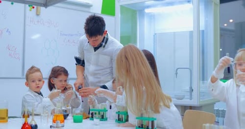 Children Studying Science With Teacher in Classroom
