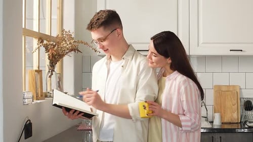 Couple Reading Together in Bright Kitchen