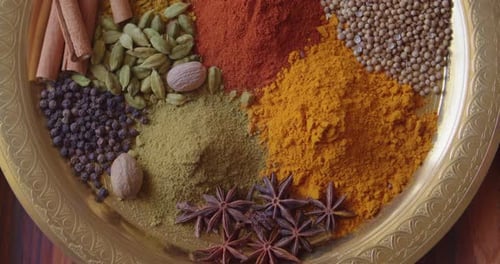 Colorful Spice Assortment on Gold Plate Still Life