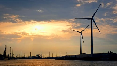 Wind Turbines in Antwerp Port on Sunset.