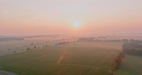 Sunrise Over the Morning Haze at Dawn on a Meadow in Summer