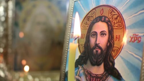 Candlelight Illuminating Religious Icon Close Up