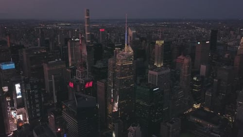 AERIAL: Manhattan Drone Flight at Night with Glowing City Light in New York City