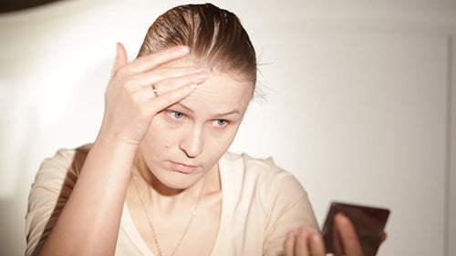 Woman Applying Makeup Looking in Compact Mirror