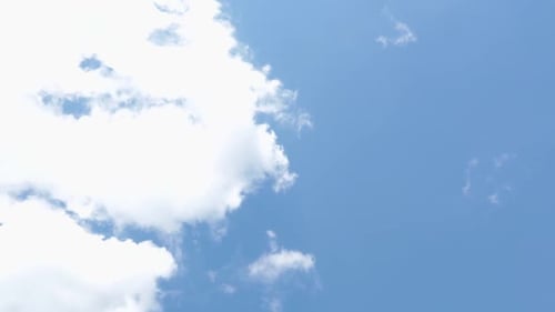 Fluffy Clouds Drifting in a Blue Sky