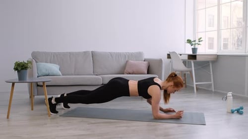 Woman Doing Plank Exercise at Home