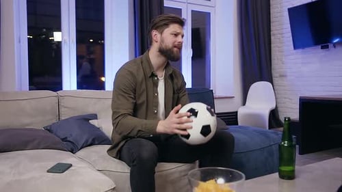 Man Watching Sports At Home At Night