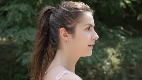 Caucasian girl walks in the forest slow motion footage