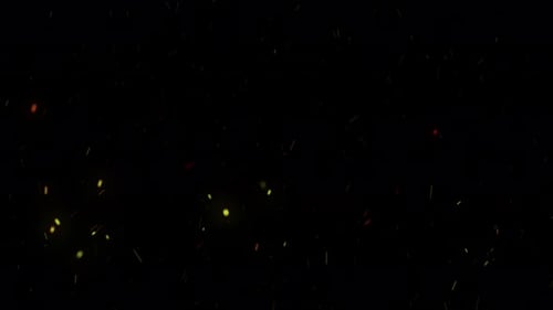 Burning red hot sparks rise in the night sky