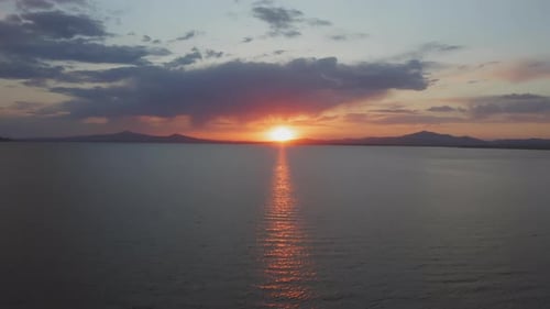 Beautiful Sunset Over the Mountain Range on the Horizon to the Sea