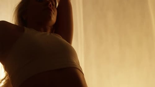 Closeup of a Professional Dancer Performing in Studio in Soft Warm Lighting