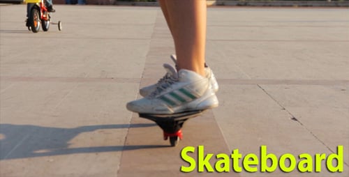 Legs on Skateboard Rolling Forward on Pavement