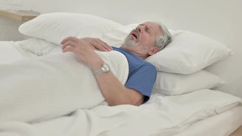 Senior Man Gasping for Breath in Bed