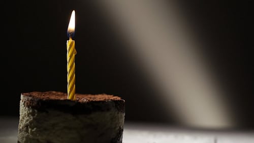 Birthday Cake with a Lit Candle