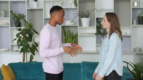 Energetic Young Couple Dancing with Joy in Home
