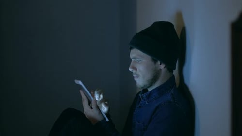 Man Using Tablet at Night in Dark Room