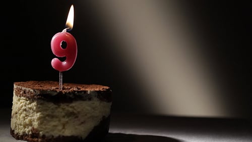 Number Nine Candle Being Lit on Birthday Cake