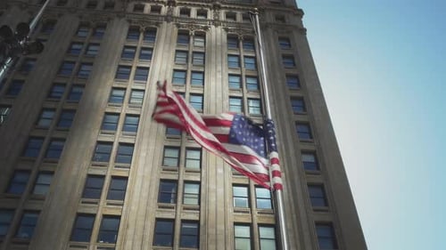 American Flag Waving at Half-Mast on Tall Building