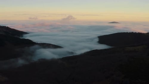 Aerial Drone Shot of Clouds and Mist Over Mountain
