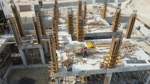 Construction Workers Building Support Structures in City