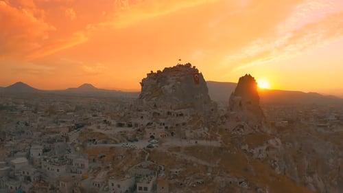 Aerial drone view at sunset with Uchisar Castle at the back in Goreme, Capadoccia, Turkey