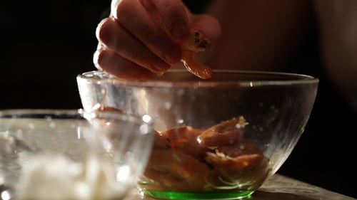 Hands Preparing Shrimp in Kitchen Bowl Close Up