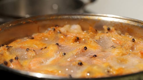 Shrimp Simmering with Pepper in a Stainless Steel Pan