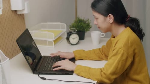 Woman working on laptop at desk