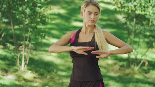 Sport Woman Training Stretching Exercise in Summer Park