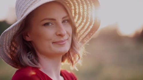 Woman Smiling in Hat at Golden Hour