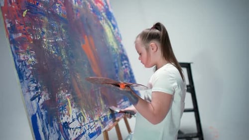 Girl Painting Abstract Art on Canvas in Studio