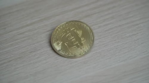 Gold Bitcoin Coin on Wood Surface