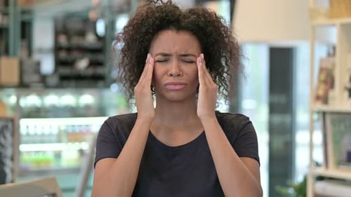 Woman Massaging Temples Due to Headache
