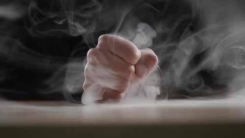 Hand Emerging from Smoke in Dramatic Close-up