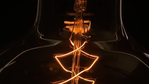 Extreme Close Up Tungsten Old Edison Retro Lamp Turn On. Light Bulb Threads Are Shaking. Light with