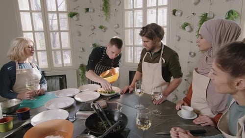 Chef Plates Salad for Group in Bright Kitchen