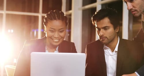 Business Colleagues Collaborating on a Laptop in Office
